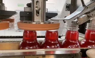 Bottles being capped during beverage production at Nutrition Labs