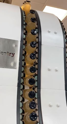 Glass bottles inverted after hot filling at Nutrition Labs for sterilization