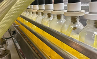 Hot filling 16oz beverage bottles on the production line at Nutrition Labs