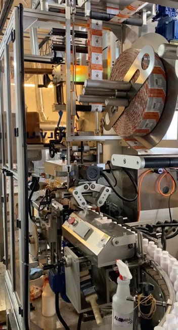 Bottles being sleeved during beverage production at Nutrition Labs